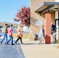 a group of people standing outside of a building