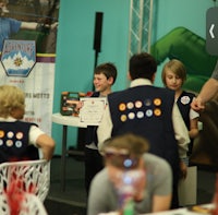 a group of boy scouts standing at a table