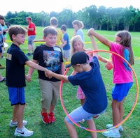 a group of kids playing hula hoop