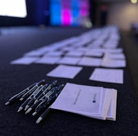 pens and paper on a table in a conference room