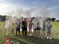 a group of people standing in a field with confetti