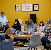 a group of people sitting in a living room